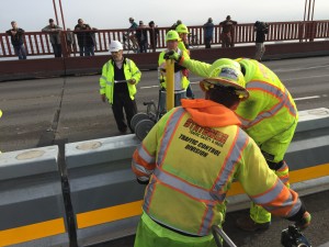 Crews work to install pieces of removable median barrier. Bridge closure. Saturday, January 10th 2015